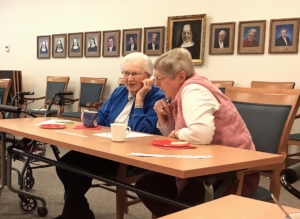 Sisters Myra and Kathleen trying to puzzle out the scrambled word.