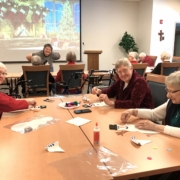 Sisters Judy, Kathleen, and Anne work on decorating their snowmen.